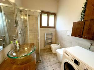 a bathroom with a sink and a washing machine at APPARTAMENTO CREMONA FIERA in Cremona