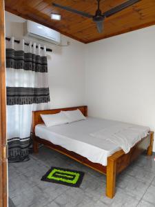 a bedroom with a bed in a room at TR Rest House in Trincomalee