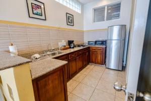 a large kitchen with a stainless steel refrigerator at Conch Suite in La Chumicosa +9 photos