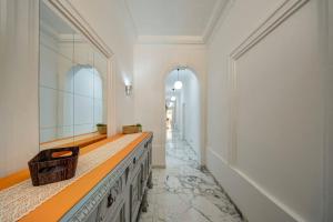 a bathroom with a long counter with a mirror and a hallway at Casa Elena, Private Garden, Office,1 Minute to the Sea by Haven & Keys Malta in Sliema +29 photos