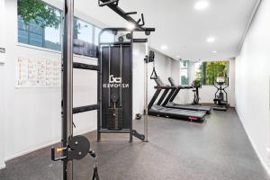 a gym with two treadmills and a treadmill at City Vista Apt with Views - Pool and Gym in Auckland