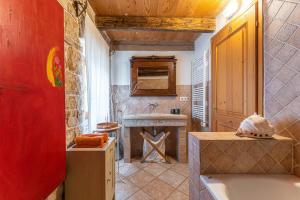 a bathroom with a stone fireplace and a sink at Una in Kranjčići - Haus für 5-6 Personen in Svetvinčenat +40 photos