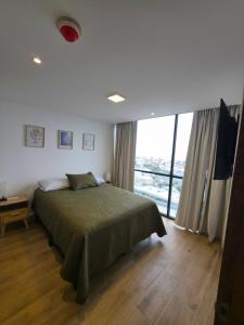 a bedroom with a bed and a large window at Modern 2BR Ocean View Pool & Kids Area CheckIn 2PM in Tijuana +35 photos