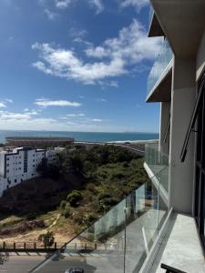 a balcony of a building with a view of the ocean at Modern 2BR Ocean View Pool & Kids Area CheckIn 2PM in Tijuana