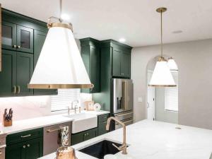 a kitchen with green cabinets and a sink at New Build, Downtown Views, next to NCH in Columbus +56 photos
