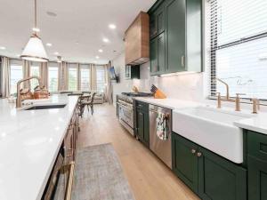 a kitchen with green cabinets and a large sink at New Build, Downtown Views, next to NCH in Columbus