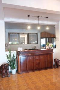 a kitchen with a large wooden island in a room at Sabaydee Guesthouse in Ban Houayxay