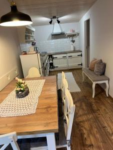 a kitchen and dining room with a table and chairs at Tulipános Vendégház in Balatonederics