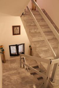 a wooden staircase in a home with a stone floor at Apartments and Rooms Villa Mir in Zaton