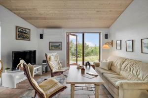 een woonkamer met een bank en een tafel bij JB363-Fjerritslev-Tolderstien-8 in Torup Strand