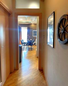 a dining room with a table and a clock on the wall at Appartamento Cremona Stazione in Cremona +3 photos