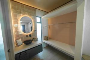 a bathroom with a sink and a mirror at Tropical Private Home for 8pp with pool in Talamanca
