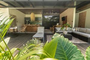 a living room with a couch and some plants at Tropical Private Home for 8pp with pool in Talamanca