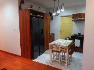 a kitchen with a table and a kitchen with yellow doors at Local & Comfortable in Mandalay +7 photos