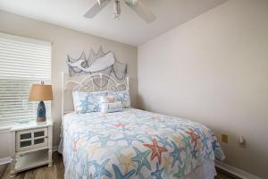a bedroom with a bed and a window and a table at Fenimore Mill 1A Mermaid's Song in Cedar Key