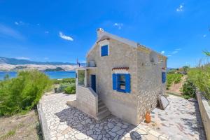 a stone house with a view of the water at Marianna in Pag - Haus für 5 Personen in Pag