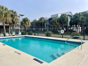 a swimming pool in front of a building at Fenimore Mill 1A Mermaid's Song in Cedar Key