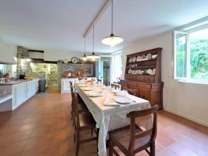 a large kitchen with a long table with chairs at Homeby, Casale Bera in Cossano Belbo +37 photos
