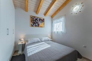 Ένα ή περισσότερα κρεβάτια σε δωμάτιο στο Modean in Pula - Haus für 2-3 Personen