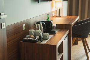 a coffeemaker sitting on a desk in a hotel room at Penzión Skalica in Skalica +109 photos