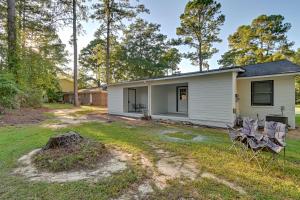 a house with two chairs in the yard at Hike and Explore Cheraw Apt 7 Mi to Lake Juniper! in Cheraw
