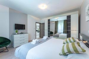 a bedroom with a large white bed and a television at Villa Božac in Cukrići - Haus für 6 Personen in Svetvinčenat +32 photos