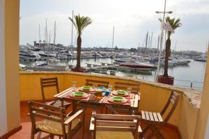 a table and chairs on a balcony with a marina at TP Coral 1 - Marina Vilamoura Apartment in Vilamoura