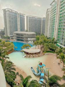 an aerial view of a resort pool with a water slide at Azure Staycation by KT in Manila