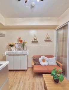 a living room with a couch and a table at Azure Staycation by KT in Manila