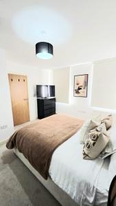 a bedroom with a large bed with a brown blanket at The ascension 'Ascalon ' in London