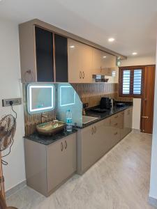 a kitchen with a sink and a counter top at Auric by Hillton in Mysore +10 photos