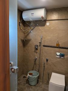 a bathroom with a toilet and a shower in it at Auric by Hillton in Mysore
