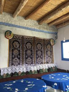 a room with two beds and a decorative wall at مأوى الكوف السياحي in M'diq +51 photos