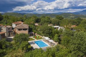an aerial view of a house with a swimming pool at Villa Dajana in Zajci - Haus für 8-10 Personen in Potpićan