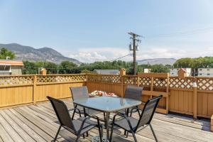 a patio with a table and chairs on a deck at Motel 6 Merritt, BC in Merritt