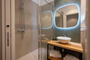 a bathroom with a sink and a shower with a mirror at New Roman Experience in Rome +56 photos