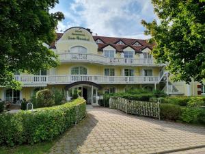 a large yellow building with a walkway in front of it at Ferienwohnung Woidtraum in Hohenwarth
