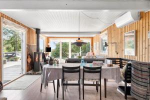 a dining room with a table and a living room at LF314-Hurup-Thy-Fjordternevej-10 in Sindrup
