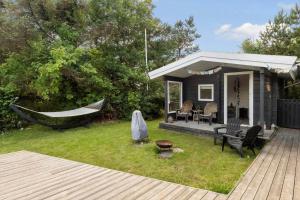 a backyard with a hammock and a house at LF314-Hurup-Thy-Fjordternevej-10 in Sindrup +11 photos