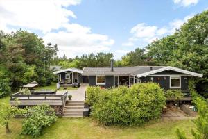 a house with a deck in the yard at LF314-Hurup-Thy-Fjordternevej-10 in Sindrup