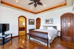 a bedroom with a bed and a flat screen tv at Casa De Los Sueos in Playa Hermosa +57 photos