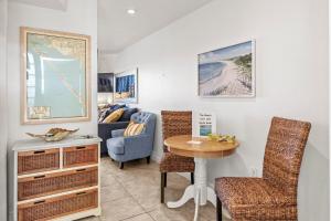 a living room with a table and a couch at Ground Floor Oceanview Open Tonight Morning Arrival Possible! in Longboat Key