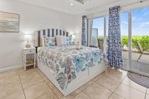 a bedroom with a bed and a balcony at Ground Floor Oceanview Open Tonight Morning Arrival Possible! in Longboat Key +64 photos