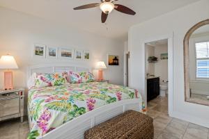 a bedroom with a bed and a ceiling fan at SC304 - Top of the Banx in Kill Devil Hills +45 photos