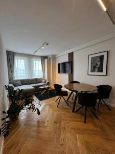 a living room with a table and a couch at RomAir Residences in Cluj-Napoca
