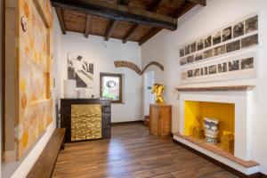 a living room with a fireplace and pictures on the walls at Museo Grillo Camere d'Arte, dormire nel Museo in Arena Po +135 photos