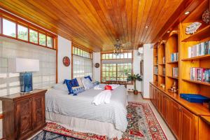 1 dormitorio con 1 cama en una habitación con estanterías en Casa Cole, en Playa Hermosa 32 fotos más
