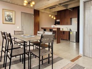 a dining room and kitchen with a table and chairs at The Hub by Wynwood House in Medellín