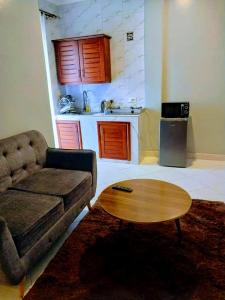 a living room with a couch and a coffee table at Dopa comfort homes in Entebbe