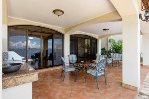 a dining room with a table and chairs on a patio at Mariners Point C1 3br Ocean-view Private Pool in Playa Hermosa